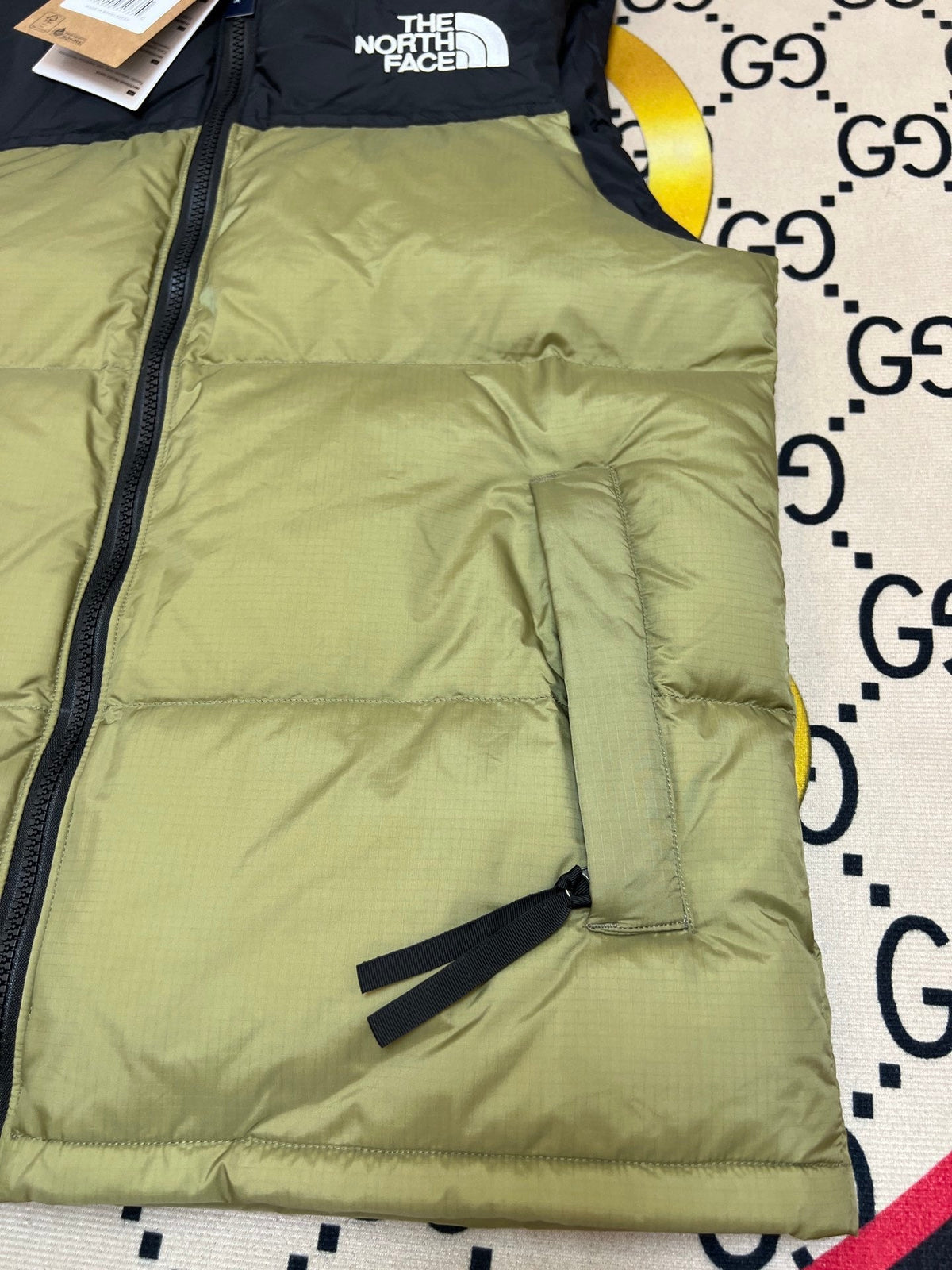 The North Face Puffer Vest in Olive Green and Black with Stand Collar
